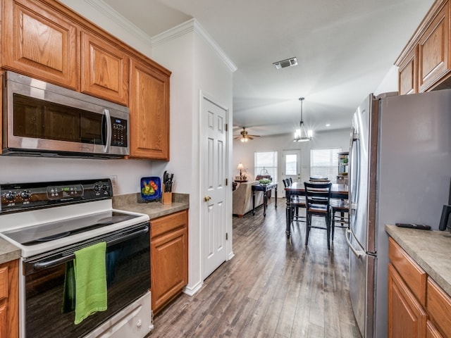 400 Autry Blvd, Gunter, TX 75058 - kitchen with appliances with stainless steel finishes, brown cabinets, a ceiling fan, wood finished floors, and decorative light fixtures