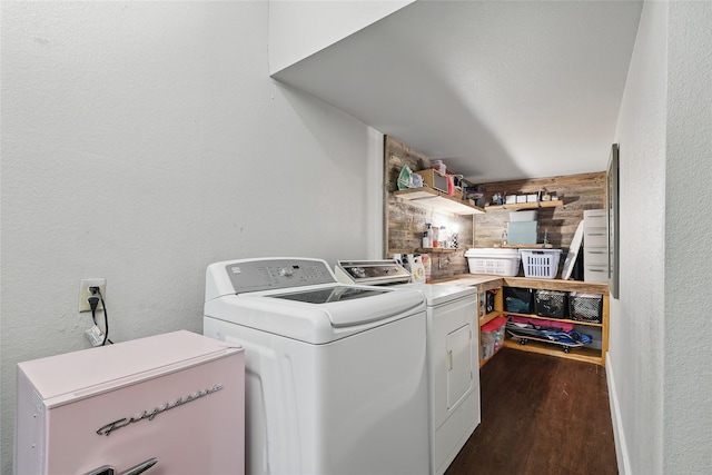 209 Walnut St, Sanger, TX 76266 - washroom featuring washing machine and clothes dryer, dark wood finished floors, a textured wall, and wood walls