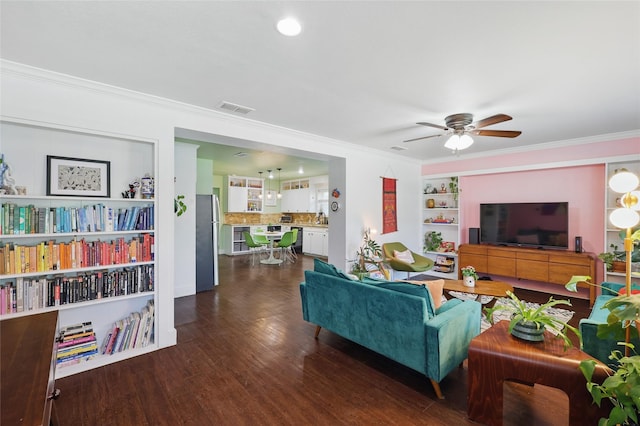 209 Walnut St, Sanger, TX 76266 - living room with crown molding, ceiling fan, dark wood-style floors, and built in shelves
