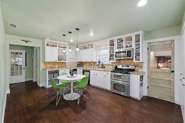 209 Walnut St, Sanger, TX 76266 - kitchen featuring open shelves, appliances with stainless steel finishes, white cabinets, decorative backsplash, and recessed lighting