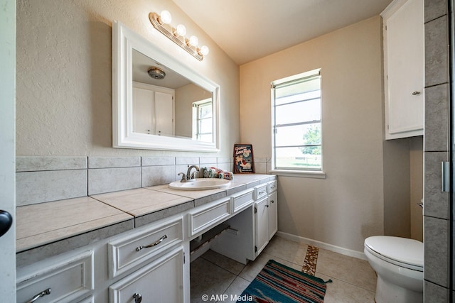 2306 County Road 475, Anson, TX 79501 - bathroom with vanity, tile patterned flooring, and tasteful backsplash