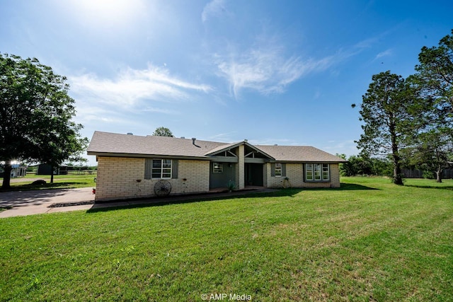 2306 County Road 475, Anson, TX 79501 - ranch-style house with a front yard and brick siding
