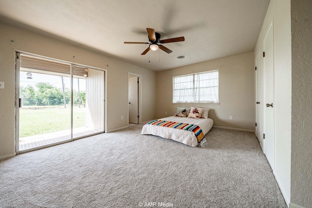 2306 County Road 475, Anson, TX 79501 - carpeted bedroom featuring access to exterior and a ceiling fan