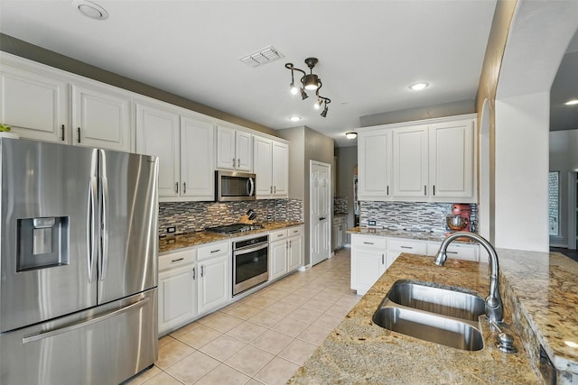 1330 Scarboro Hills Ln, Rockwall, TX 75087 - kitchen with stainless steel appliances, light tile patterned flooring, tasteful backsplash, white cabinetry, and recessed lighting