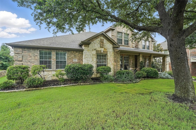 1330 Scarboro Hills Ln, Rockwall, TX 75087 - view of front of house with stone siding, a front lawn, and roof with shingles