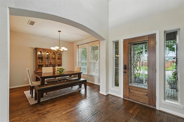 1330 Scarboro Hills Ln, Rockwall, TX 75087 - entrance foyer with arched walkways, healthy amount of natural light, a chandelier, and dark wood-type flooring