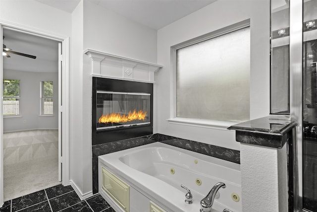 908 Trinity Dr, Lancaster, TX 75146 - full bathroom featuring a jetted tub, a glass covered fireplace, and tile patterned flooring
