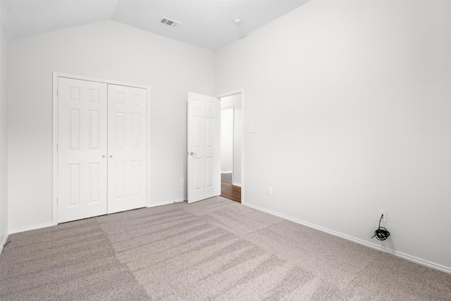 908 Trinity Dr, Lancaster, TX 75146 - unfurnished bedroom featuring carpet flooring, lofted ceiling, and a closet