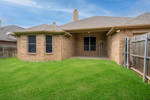 908 Trinity Dr, Lancaster, TX 75146 - back of property featuring brick siding, a shingled roof, a chimney, and a patio area