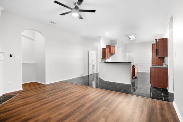 908 Trinity Dr, Lancaster, TX 75146 - unfurnished living room with a ceiling fan, dark wood-style floors, and arched walkways