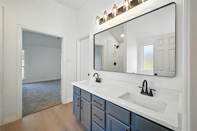 713 Madeline Ct, Azle, TX 76020 - bathroom with double vanity, wood finished floors, and a tile shower