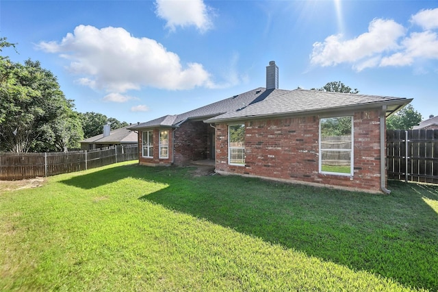 713 Madeline Ct, Azle, TX 76020 - back of house featuring brick siding, a fenced backyard, and a chimney