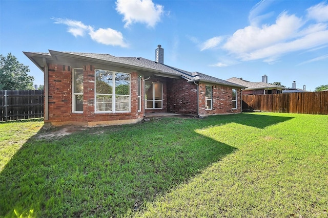 713 Madeline Ct, Azle, TX 76020 - rear view of house with a fenced backyard, brick siding, and a chimney