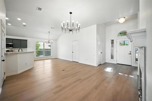 713 Madeline Ct, Azle, TX 76020 - unfurnished living room featuring a chandelier, wood finished floors, recessed lighting, and high vaulted ceiling