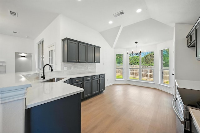 713 Madeline Ct, Azle, TX 76020 - kitchen with light wood finished floors, a peninsula, a chandelier, light countertops, and backsplash