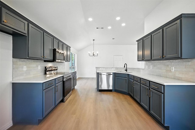 713 Madeline Ct, Azle, TX 76020 - kitchen with stainless steel appliances, a chandelier, light wood-style floors, vaulted ceiling, and tasteful backsplash
