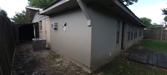2914 Satsuma Dr, Dallas, TX 75229 - view of home's exterior featuring a fenced backyard, stucco siding, a wall mounted air conditioner, and a shed
