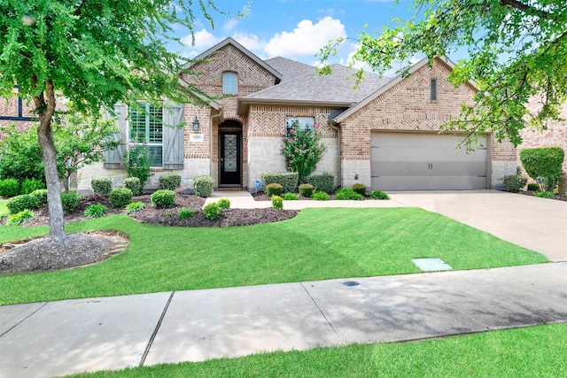 9809 Trinity Dr, Little Elm, TX 75068 - view of front of house with brick siding, driveway, stone siding, and a garage