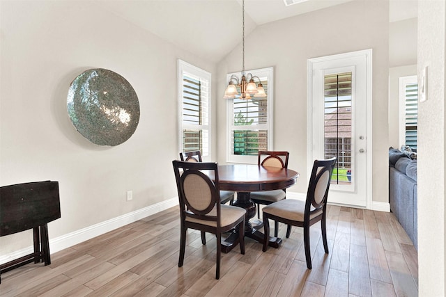 9809 Trinity Dr, Little Elm, TX 75068 - dining room featuring a chandelier, light wood-style flooring, and vaulted ceiling