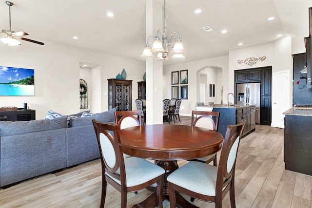 9809 Trinity Dr, Little Elm, TX 75068 - dining area featuring light wood-style floors, ceiling fan, arched walkways, a chandelier, and recessed lighting