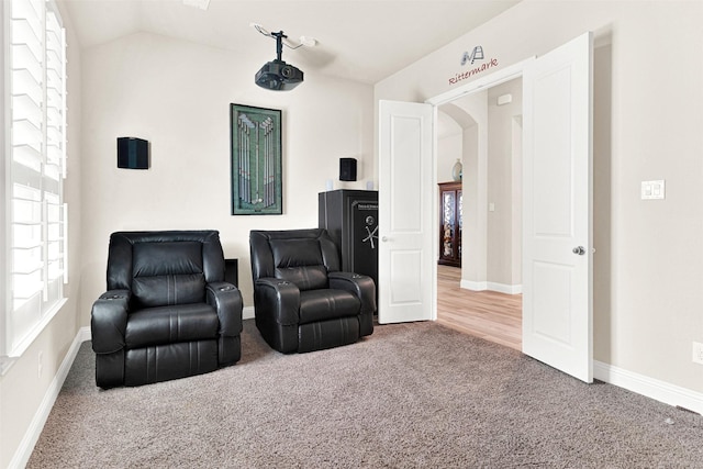 9809 Trinity Dr, Little Elm, TX 75068 - sitting room featuring carpet, vaulted ceiling, and arched walkways