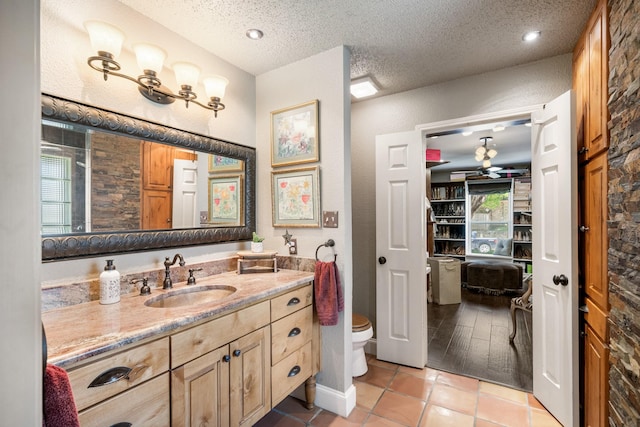 3901 Woodside Dr, Arlington, TX 76016 - bathroom with vanity, tile patterned floors, a textured ceiling, ceiling fan, and plenty of natural light