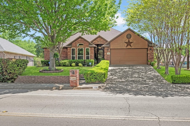 3901 Woodside Dr, Arlington, TX 76016 - view of front facade with brick siding, a garage, driveway, and a front yard