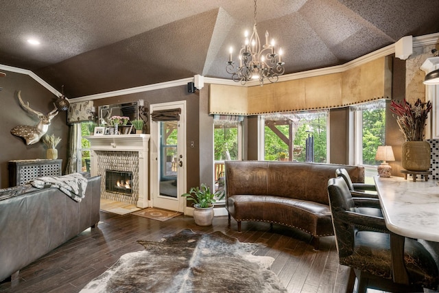3901 Woodside Dr, Arlington, TX 76016 - living room with vaulted ceiling, wood-type flooring, a chandelier, a tiled fireplace, and ornamental molding