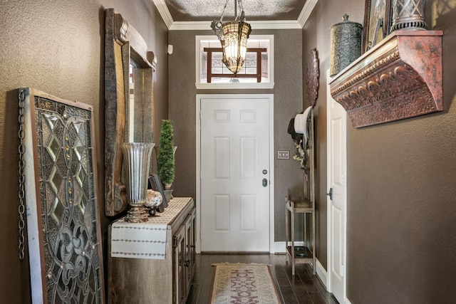 3901 Woodside Dr, Arlington, TX 76016 - entryway with a textured wall, a chandelier, crown molding, and dark wood-style flooring