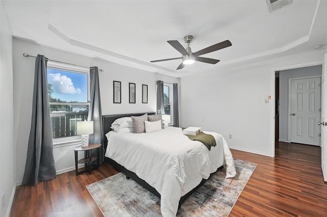 515 Signal Hill Ct S, Fort Worth, TX 76112 - bedroom with a tray ceiling, multiple windows, wood finished floors, and a ceiling fan