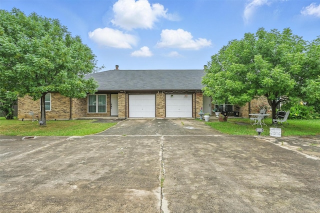 515 Signal Hill Ct S, Fort Worth, TX 76112 - view of front of house featuring an attached garage, asphalt driveway, brick siding, and a front lawn