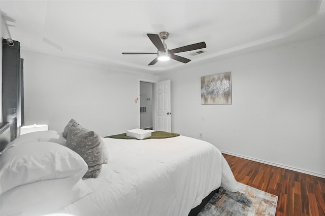515 Signal Hill Ct S, Fort Worth, TX 76112 - bedroom with wood finished floors, a raised ceiling, and a ceiling fan