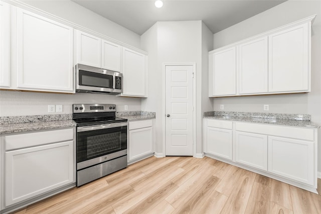 4020 Centerfire Rd, Waco, TX 76705 - kitchen featuring appliances with stainless steel finishes, white cabinetry, light wood-style floors, recessed lighting, and light stone countertops