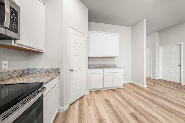 4020 Centerfire Rd, Waco, TX 76705 - kitchen featuring appliances with stainless steel finishes, light wood-style floors, white cabinetry, and light stone counters