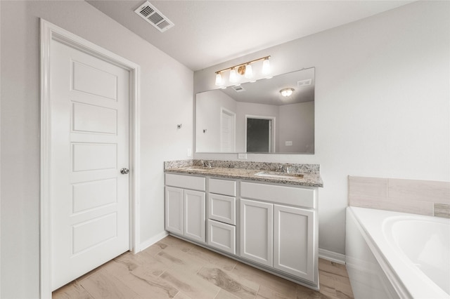 4020 Centerfire Rd, Waco, TX 76705 - bathroom featuring double vanity and a bath