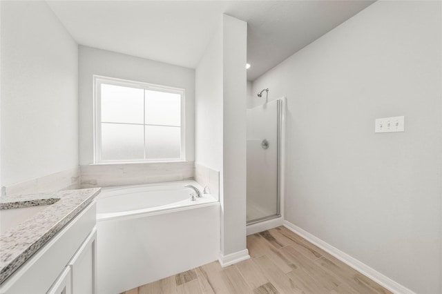 4020 Centerfire Rd, Waco, TX 76705 - bathroom featuring a bath, vanity, a stall shower, and wood finished floors