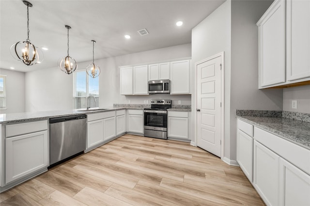 4020 Centerfire Rd, Waco, TX 76705 - kitchen featuring stainless steel appliances, a chandelier, recessed lighting, white cabinetry, and hanging light fixtures