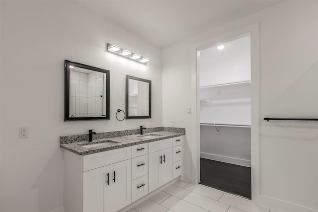 407 Dubois Ave, Dallas, TX 75203 - bathroom with double vanity, a spacious closet, and tile patterned floors