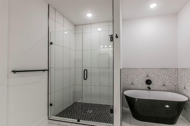 407 Dubois Ave, Dallas, TX 75203 - bathroom with a soaking tub, a shower stall, and recessed lighting