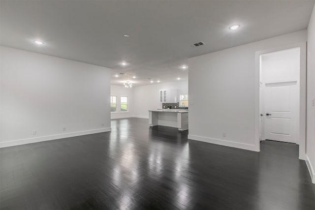 407 Dubois Ave, Dallas, TX 75203 - unfurnished living room featuring dark wood-type flooring and recessed lighting
