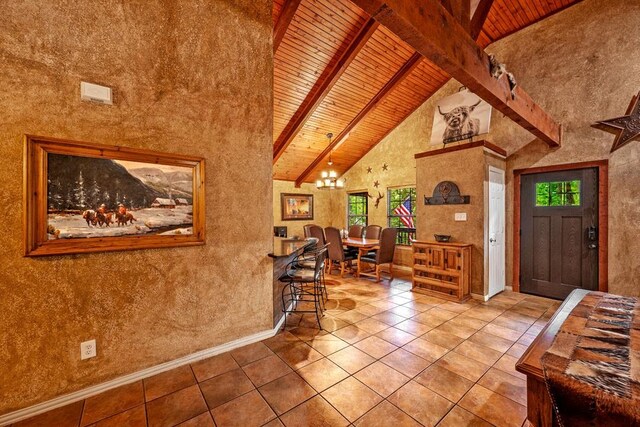 188 Hacienda, Pottsboro, TX 75076 - entrance foyer with a wooden ceiling with exposed beams, a chandelier, tile patterned flooring, and high vaulted ceiling