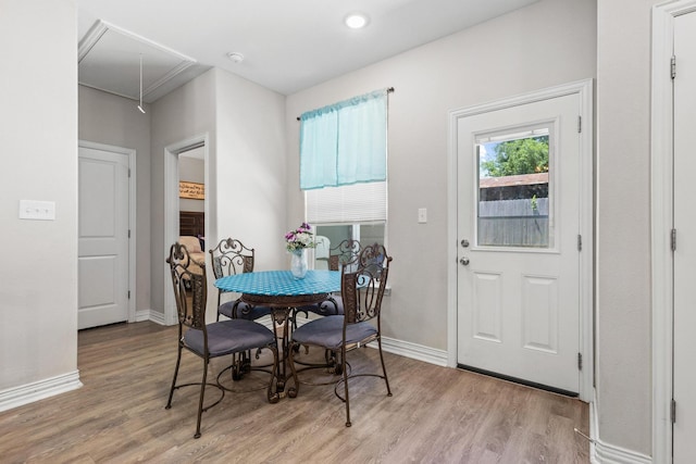 409 N Houston Ave, Denison, TX 75021 - dining area featuring attic access and light wood-style floors
