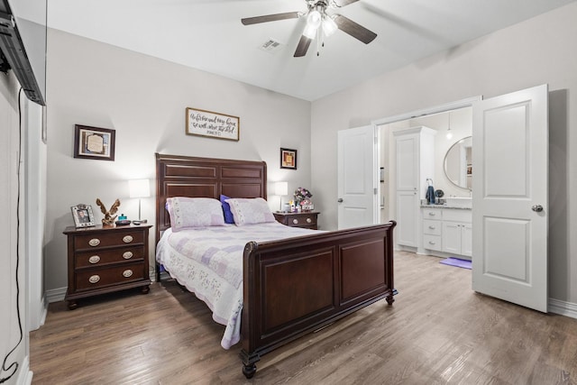 409 N Houston Ave, Denison, TX 75021 - bedroom with light wood-type flooring, ensuite bathroom, and ceiling fan