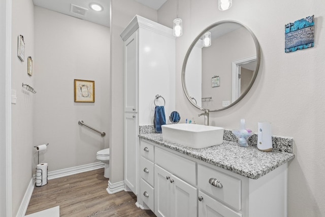 409 N Houston Ave, Denison, TX 75021 - bathroom with vanity and wood finished floors