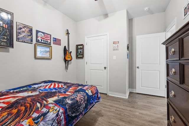409 N Houston Ave, Denison, TX 75021 - bedroom featuring light wood-style floors and baseboards