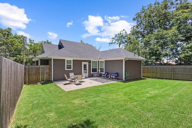 409 N Houston Ave, Denison, TX 75021 - rear view of house featuring roof with shingles, a fenced backyard, and a patio area