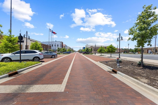 409 N Houston Ave, Denison, TX 75021 - view of decorative street with street lighting, curbs, and a residential view