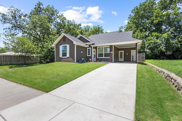 409 N Houston Ave, Denison, TX 75021 - ranch-style home with concrete driveway, an attached carport, and a shingled roof