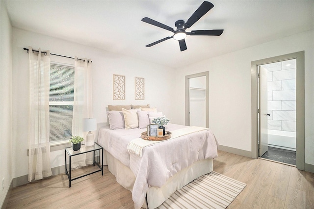 5525 Lester Granger Dr, Fort Worth, TX 76112 - bedroom with light wood-style flooring, a ceiling fan, and connected bathroom