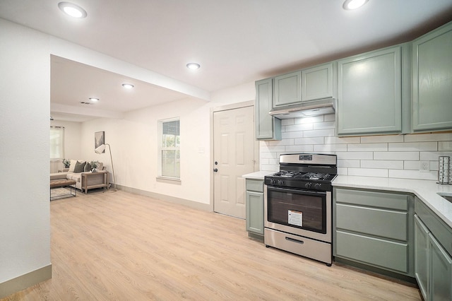 5525 Lester Granger Dr, Fort Worth, TX 76112 - kitchen with stainless steel gas range, light countertops, decorative backsplash, under cabinet range hood, and recessed lighting